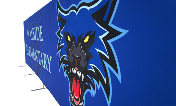 photo of twenty foot long renovate partition with snarling wolf head graphic and wayside elementary