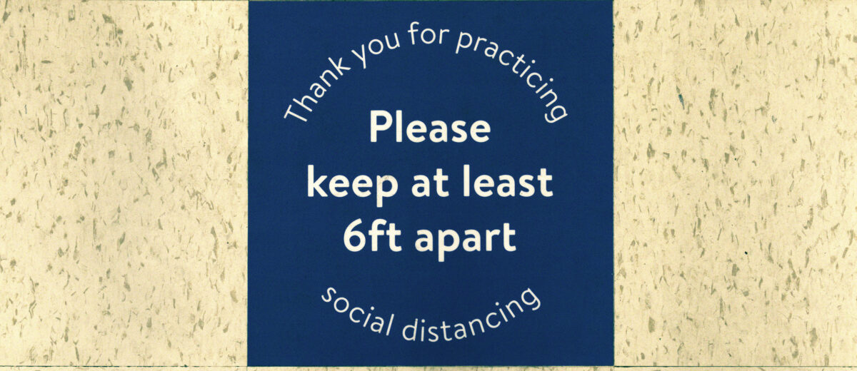 Floor sign at a supermarket in Raleigh, NC during coronavirus quarantine saying "thank you for practicing social distancing. Please keep at least 6 feet apart".